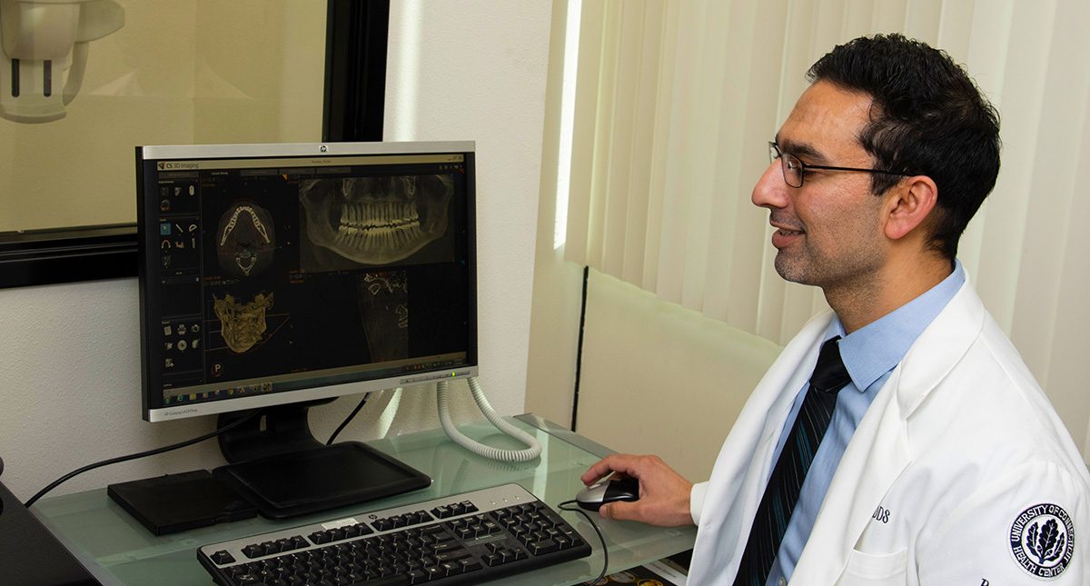 Dentist planning dental implant treatment using software